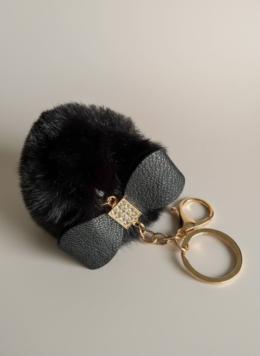 Schlüssel-/Taschenanhänger mit Schleife und Pompom schwarz/beige
