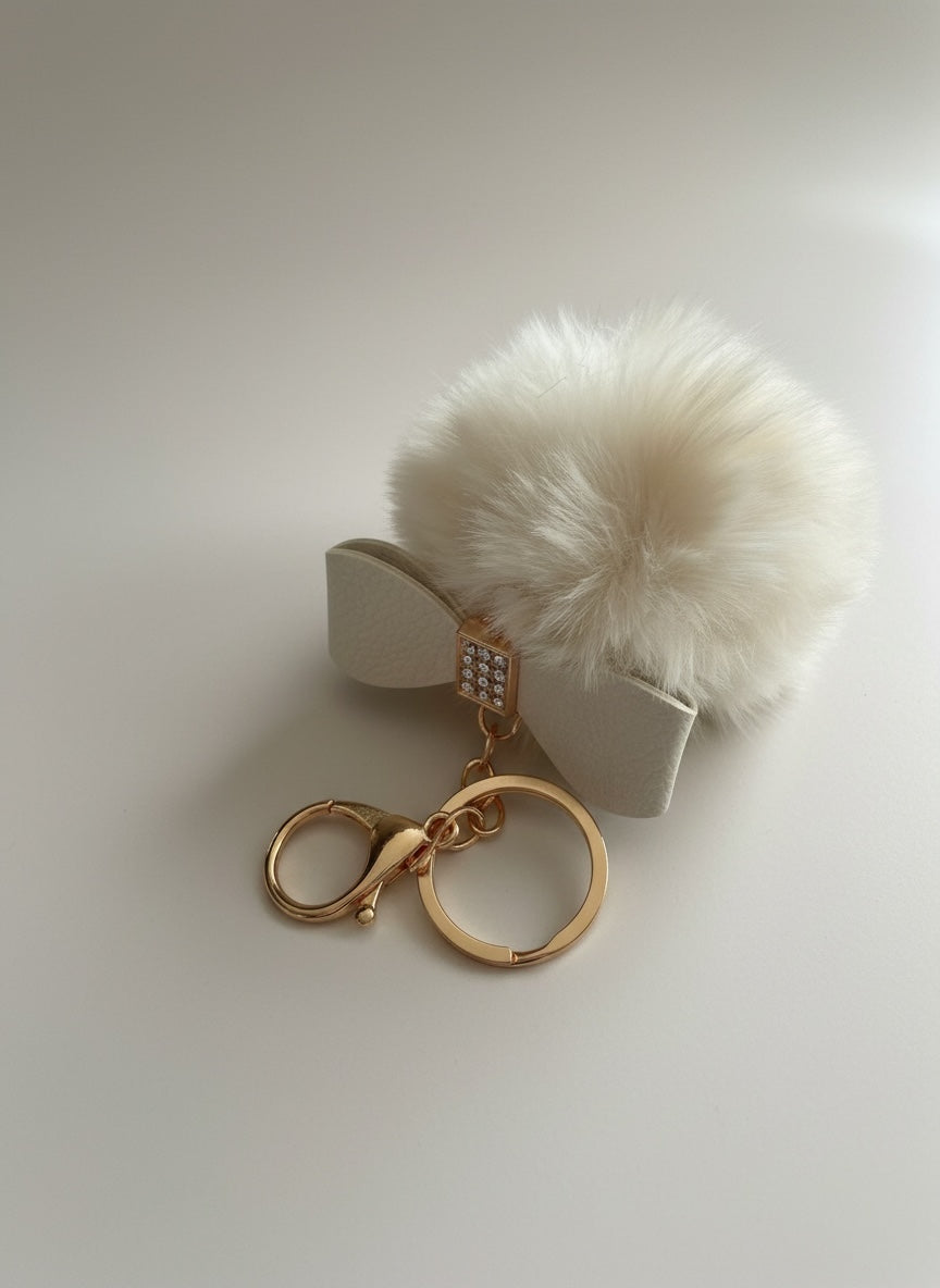 Schlüssel-/Taschenanhänger mit Schleife und Pompom schwarz/beige